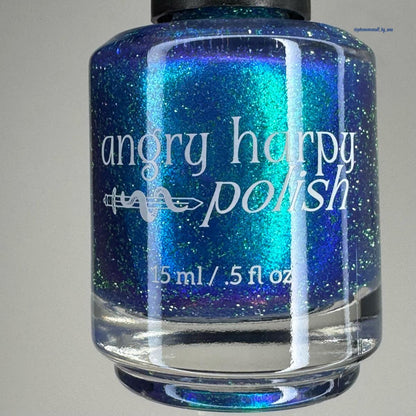 A bottle of nail polish with a black cap and white text reading 'angry harpy polish' and '15 ml / .5 fl oz'.